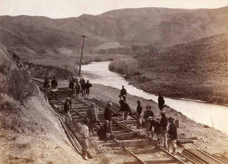 Immigrants laying railroad tracks