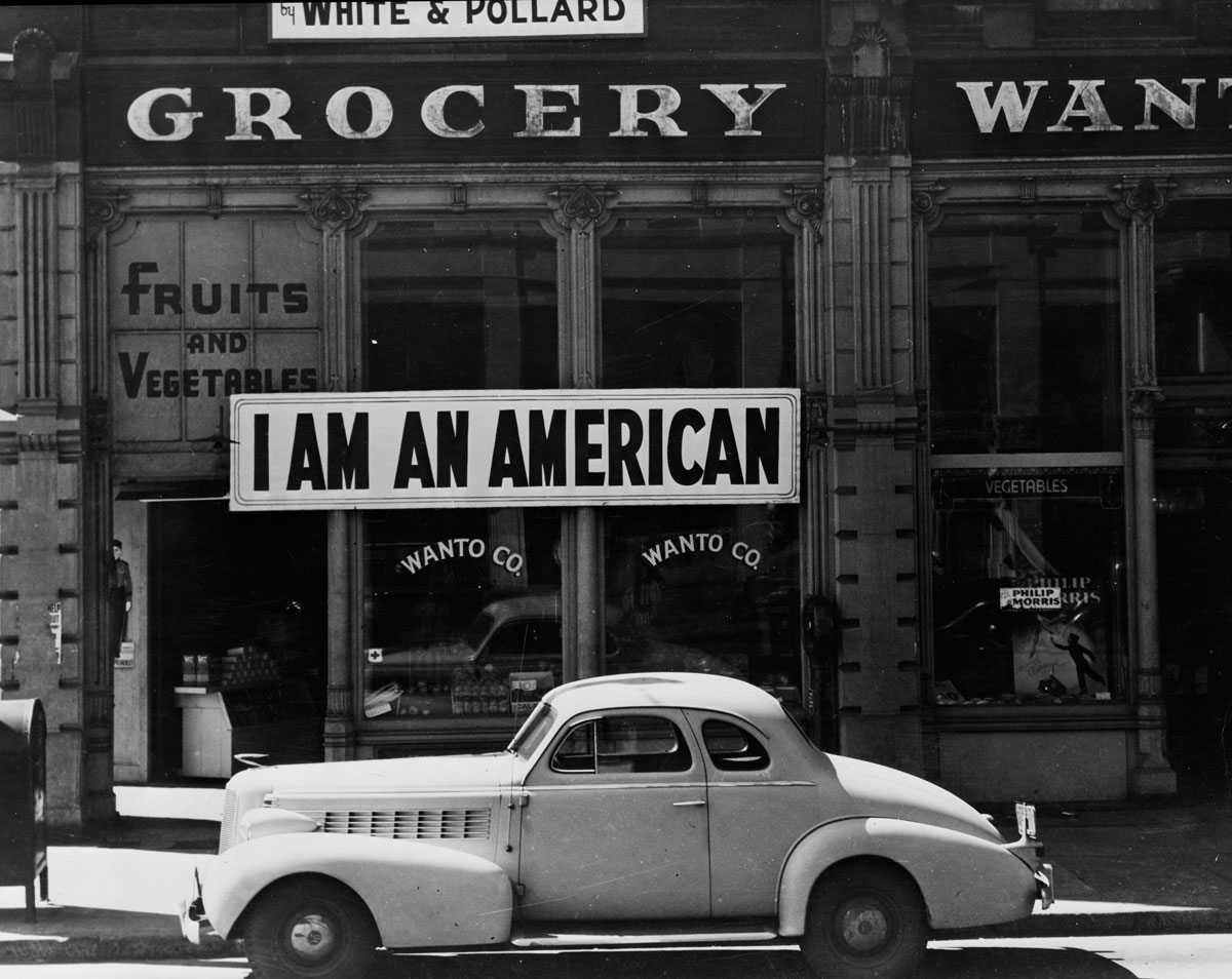 A sign in Oakland, CA. reading "I am an American"