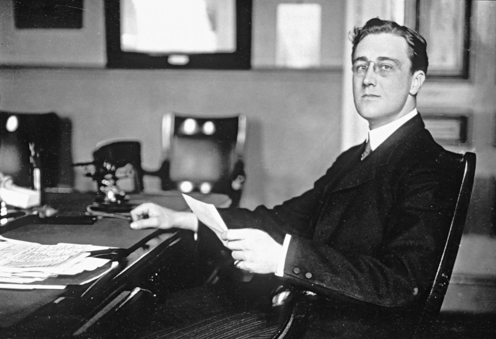 Franklin Delano Roosevelt sitting at a desk